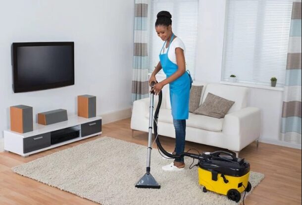 woman cleaning up living room
