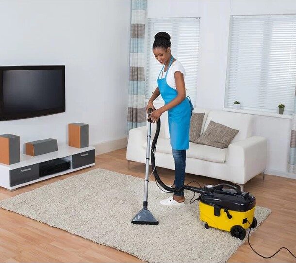 woman cleaning up living room