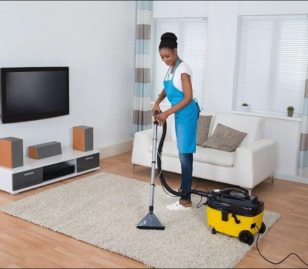 woman cleaning up living room