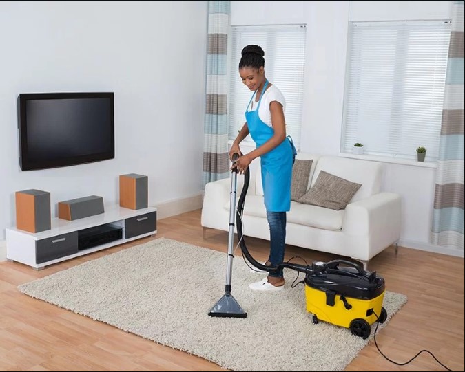 woman cleaning up living room